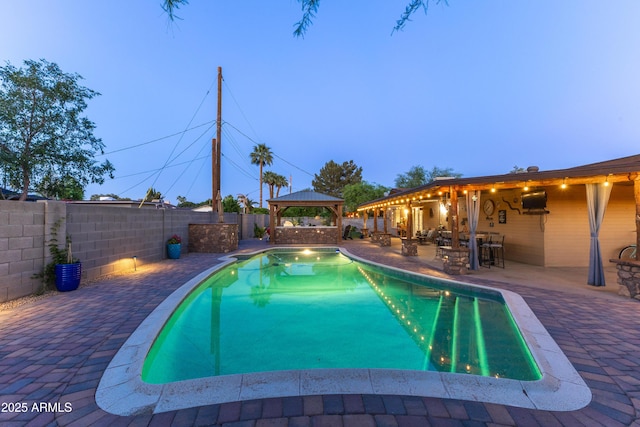 view of pool featuring a gazebo, a fenced backyard, a patio area, and a fenced in pool