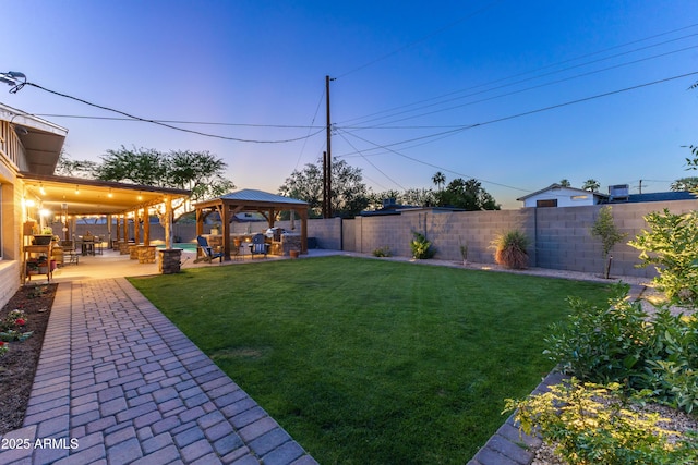 view of yard with a fenced backyard, a gazebo, and a patio area