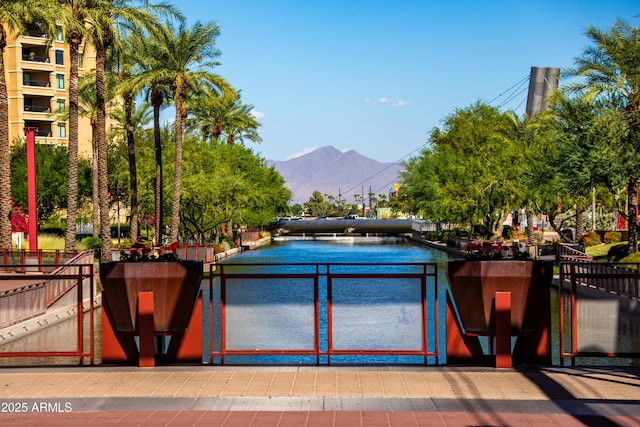 view of swimming pool featuring a mountain view and fence