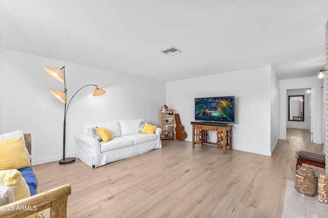 living area with visible vents and light wood finished floors