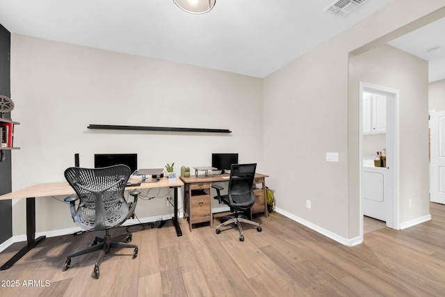 office with washer / dryer and light wood-type flooring