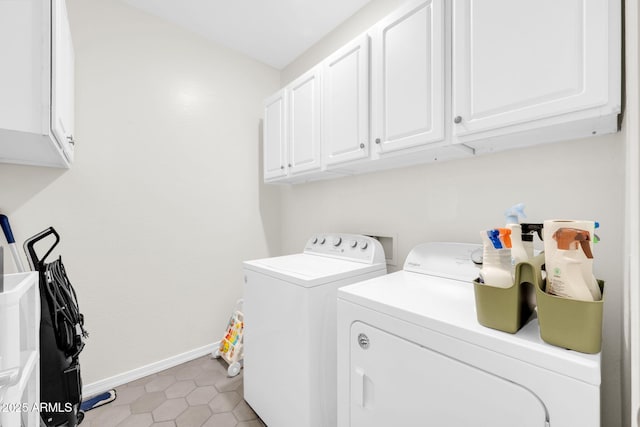 laundry room featuring washer and dryer, light tile patterned floors, and cabinets