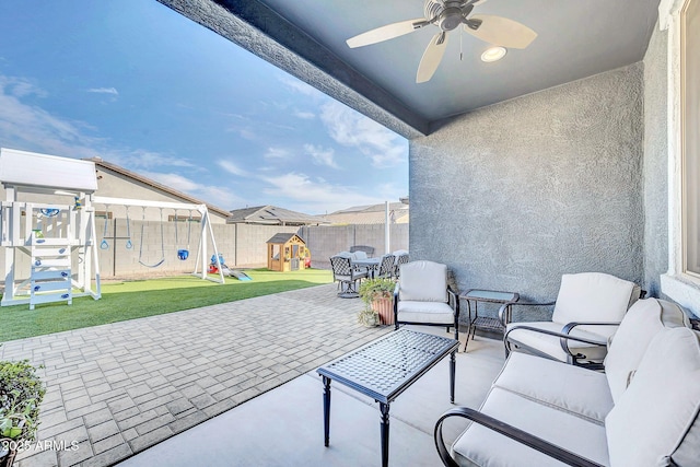 view of patio featuring ceiling fan, an outdoor hangout area, and a playground