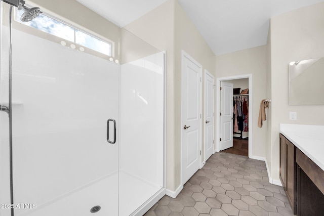 bathroom featuring vanity and a shower with shower door