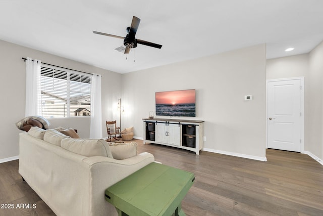 living room featuring dark hardwood / wood-style floors and ceiling fan