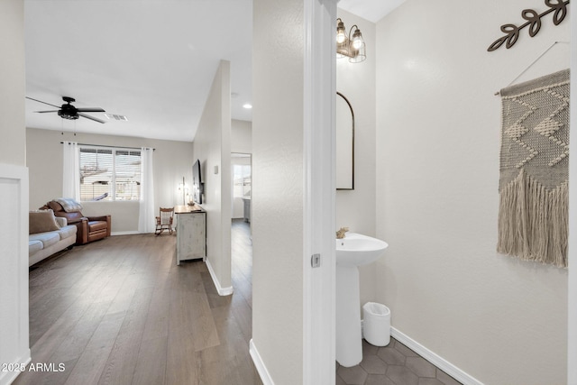 bathroom with hardwood / wood-style floors and ceiling fan