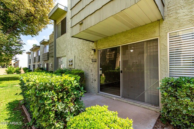 property entrance featuring stucco siding