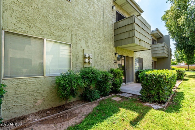 exterior space featuring a yard and stucco siding