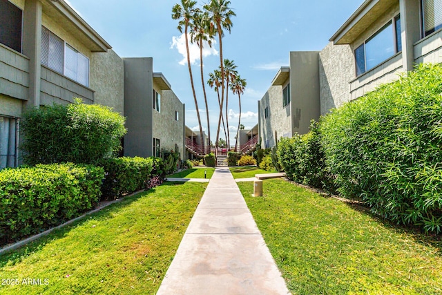 view of community featuring a yard and a residential view