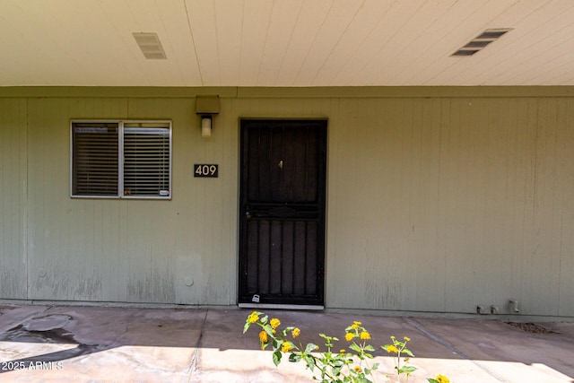 view of exterior entry with visible vents