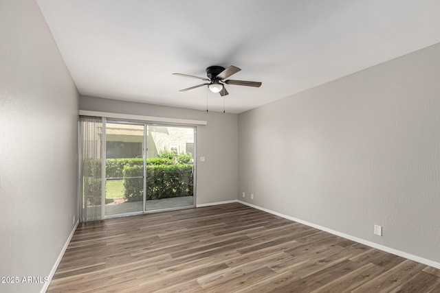 unfurnished room with baseboards, a ceiling fan, and wood finished floors