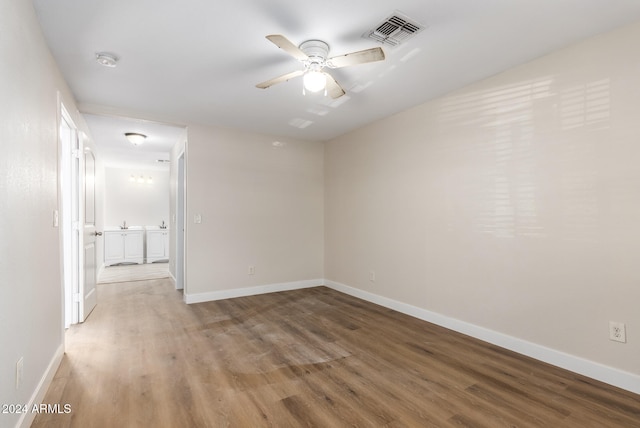 unfurnished room with hardwood / wood-style flooring and ceiling fan