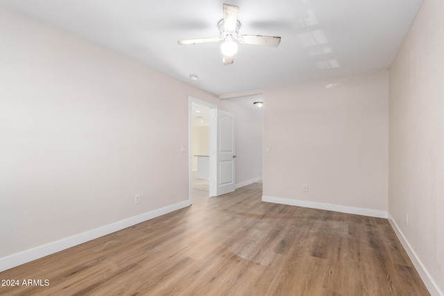 spare room featuring ceiling fan and light wood-type flooring