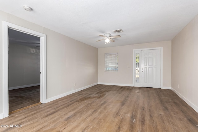 empty room with hardwood / wood-style flooring and ceiling fan