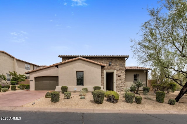 20055 N 96th Way, Scottsdale, AZ 85255 - mediterranean / spanish-style house featuring stone siding, an attached garage, stucco siding, concrete driveway, and a tile roof