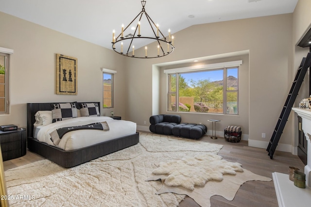 20055 N 96th Way, Scottsdale, AZ 85255 - bedroom with a chandelier, wood finished floors, vaulted ceiling, and baseboards