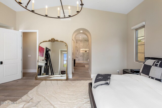 20055 N 96th Way, Scottsdale, AZ 85255 - bedroom featuring wood finished floors, a chandelier, a towering ceiling, ensuite bathroom, and baseboards
