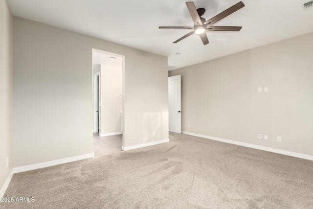 empty room featuring baseboards, visible vents, ceiling fan, and carpet