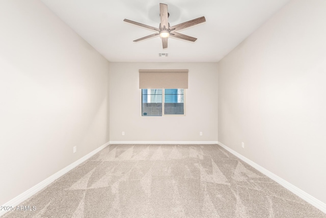 carpeted empty room featuring a ceiling fan, baseboards, and visible vents