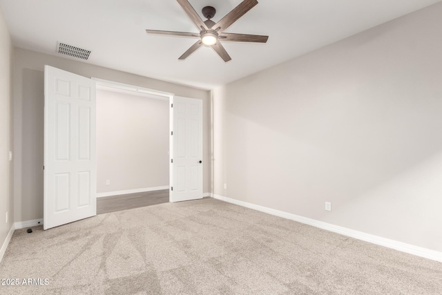 unfurnished bedroom with visible vents, baseboards, ceiling fan, and carpet floors