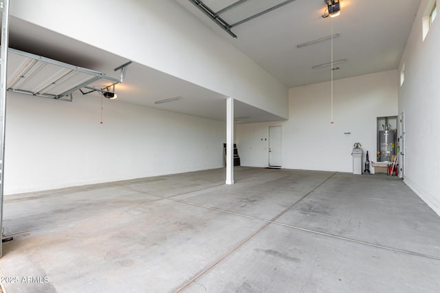 garage with water heater and a garage door opener
