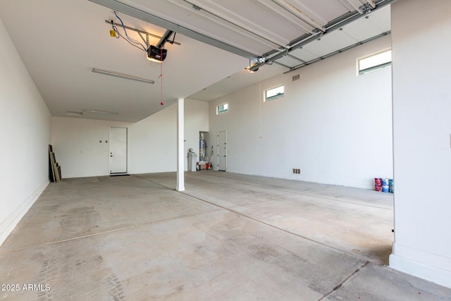 garage with water heater and a garage door opener