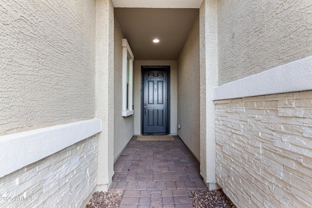 view of exterior entry featuring stucco siding