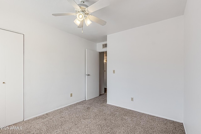 unfurnished bedroom with carpet floors, baseboards, visible vents, and ceiling fan