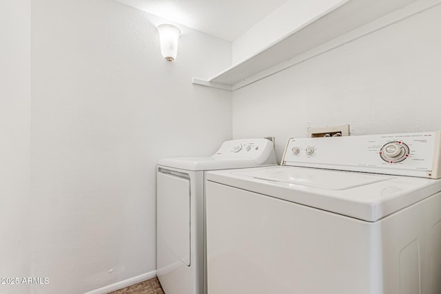 washroom with independent washer and dryer, laundry area, and baseboards