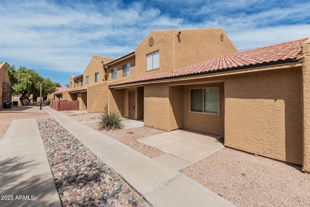 exterior space with a residential view, a patio, and stucco siding