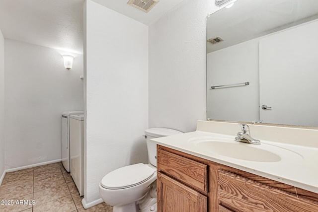 bathroom featuring washer and dryer, toilet, visible vents, and vanity