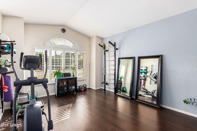 exercise area with vaulted ceiling and dark hardwood / wood-style flooring