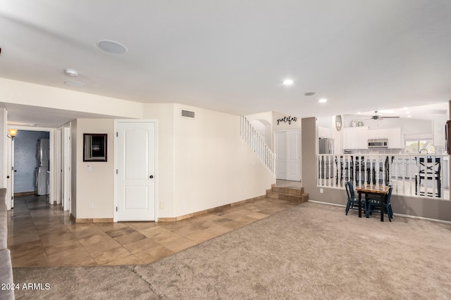 interior space with ceiling fan