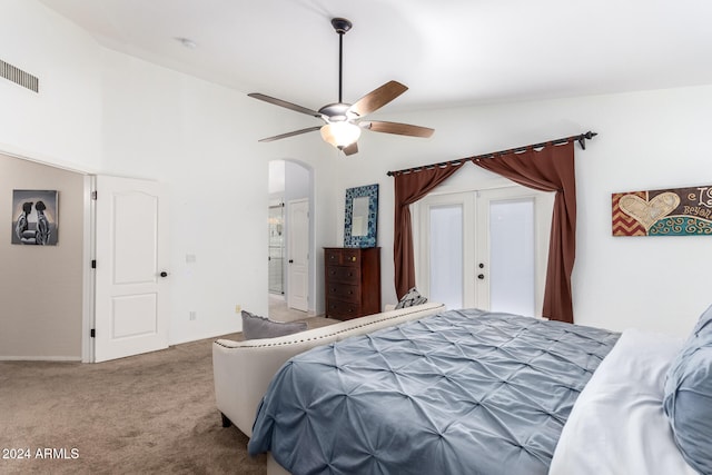 carpeted bedroom featuring lofted ceiling, ceiling fan, and french doors