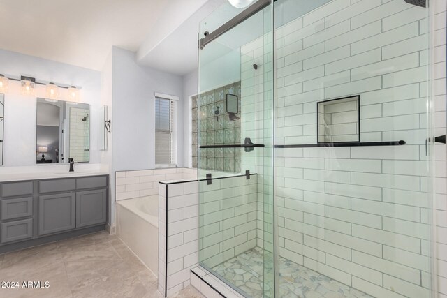 bathroom featuring independent shower and bath and vanity