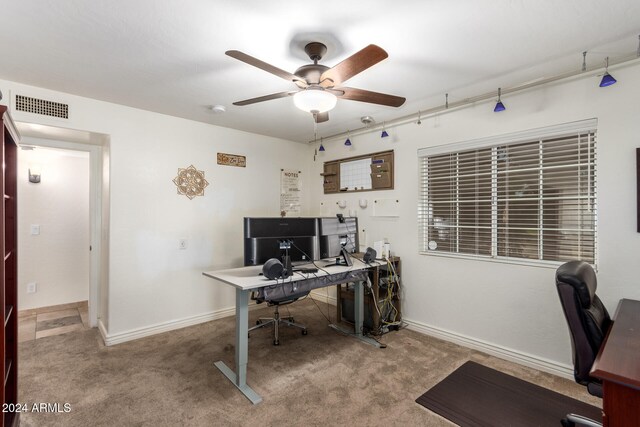 carpeted home office featuring ceiling fan