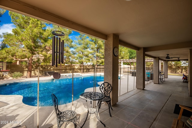 view of pool with ceiling fan and a patio