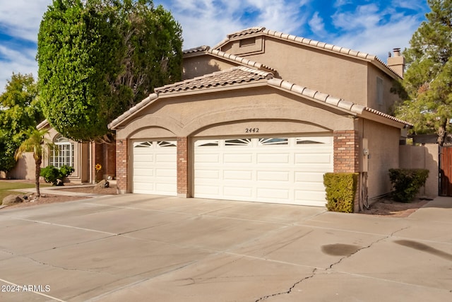 mediterranean / spanish house with a garage