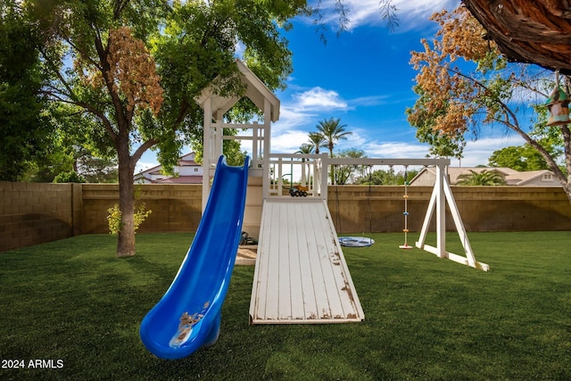 view of playground with a lawn