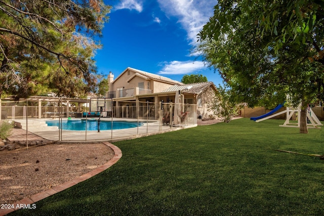 view of pool with a patio and a yard