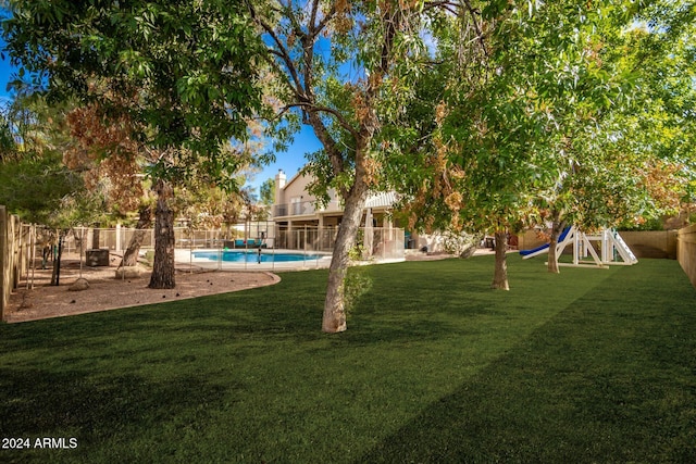 view of yard with a fenced in pool