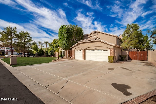 view of front of property with a garage and a front lawn