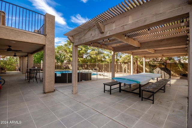 view of patio / terrace featuring a pergola, ceiling fan, and a fenced in pool