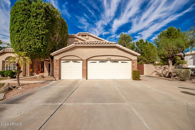 mediterranean / spanish-style house with a garage