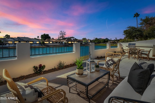 patio terrace at dusk with a pool