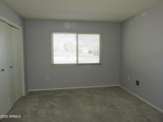 unfurnished bedroom with carpet flooring and a closet