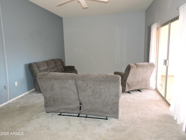 carpeted living room featuring ceiling fan