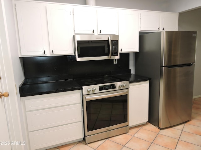 kitchen with white cabinetry, light tile patterned flooring, and appliances with stainless steel finishes