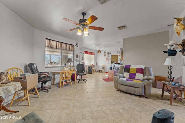 tiled living room with ceiling fan