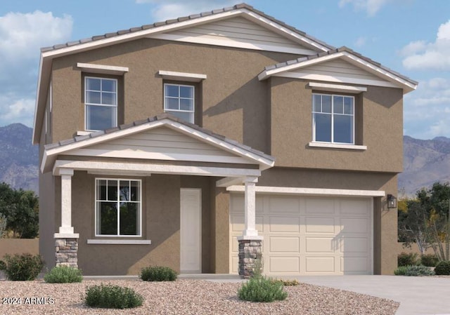 view of front of property with a mountain view and a garage